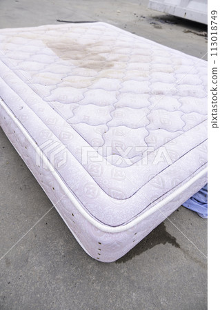 Detail of old damaged mattress thrown into the trash, recycling Detail of old damaged mattress thrown into the trash, recycling 113018749