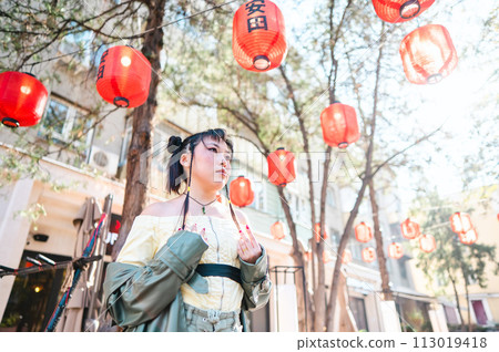 Portrait of an Asian woman against the background of Chinese lanterns.  113019418
