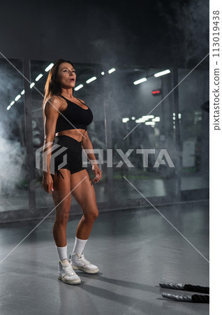 Caucasian woman resting after exercise with ropes. Caucasian woman resting after exercise with ropes. 113019438