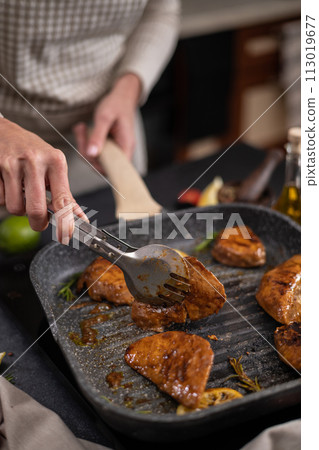 marinated pieces of Organic Tuna Steak frying on a hot grill pan 113019677