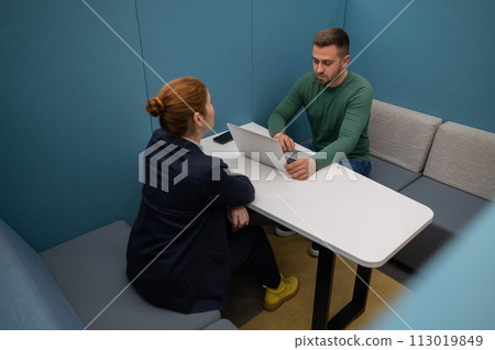Caucasian woman and bearded man at the talks in the room. Job interview. Caucasian woman and bearded man at the talks in the room. Job interview. 113019849
