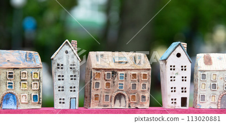 Small toy houses on a background of greenery. Toy street. 113020881
