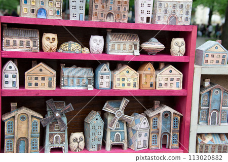 Lots of little toy houses for sale. 113020882