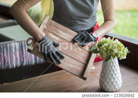 Gloved hands hold a tray in a restaurant. Gloved hands hold a tray in a restaurant. 113020892