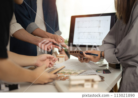 Group of designers of interior choosing material samples, working together at creative office Group of designers of interior choosing material samples, working together at creative office 113021890