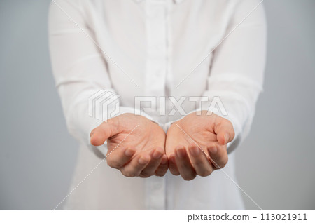 Close-up of female hands with palms up.  113021911