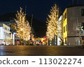 Illuminated night view of a town with a railroad crossing 113022274
