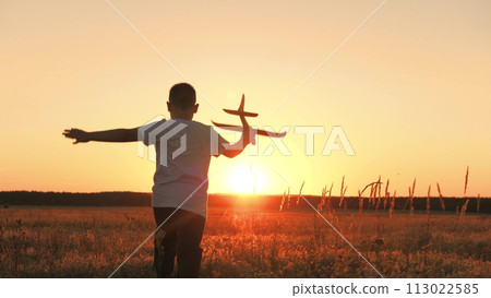 boy runs with plane his hand, child boy plays with toy plane, child son runs happily through field sunset, fantastic dream airplane pilot, cheerful child boy runs happily with toy plane through park boy runs with plane his hand, child boy plays with toy plane, child son runs happily through field sunset, fantastic dream airplane pilot, cheerful child boy runs happily with toy plane through park 113022585