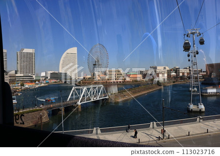 Views from riding in Yokohama Air Cabin showing Yokohama's Minatomirai area from above through the mirrored windows. In Yokohama Japan. 113023716