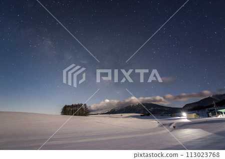 The Milky Way rises from the larch hills of Tsumagoi Kogen over a snowy field illuminated by moonlight The Milky Way rises from the larch hills of Tsumagoi Kogen over a snowy field illuminated by moonlight 113023768