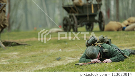 Re-enactor Dressed As German Wehrmacht Soldier Lies Slain In Reconstruction Of Battles World War Ii. German Soldier Uniform. German Infantry Soldier In World War Ii. Win Of Soviet Army In War 113023914
