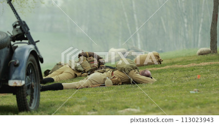 Soviet Russian Infantry Soldier In World War Ii. Re-enactor Dressed As Soviet Russian Soldier Lies Slain In Reconstruction Of Battles World War I Near Combat Sidecar. Soviet Russian Soldiers Uniform 113023943