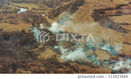 Aerial View. Spring Dry Grass Burns During Drought Hot Weather. Bush Fire And Smoke In Meadow Field. Wild Open Fire Destroys Grass. Nature In Danger. Ecological Problem Air Pollution. Natural Disaster 113023984