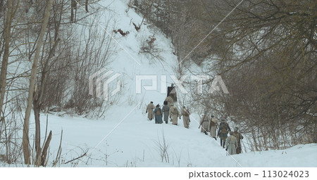 Men Dressed As White Guard Soldiers Of Imperial Russian Army In Russian Civil War s Marching Through Snowy Winter Forest. Historical Reenactment of Civil War Men Dressed As White Guard Soldiers Of Imperial Russian Army In Russian Civil War s Marching Through Snowy Winter Forest. Historical Reenactment of Civil War 113024023