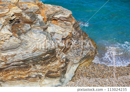 Seascape on a sunny day. Rocky sea coast on the Beach Playa de Las Catedrales in Ribadeo, Galicia, Spain, Europe Seascape on a sunny day. Rocky sea coast on the Beach Playa de Las Catedrales in Ribadeo, Galicia, Spain, Europe 113024235