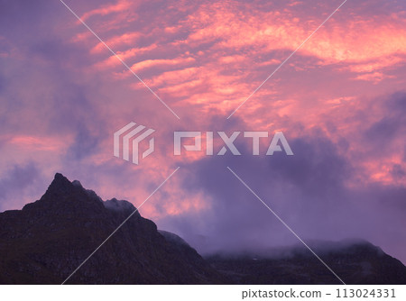 Silhouette of mountains against the purple sunset sky. Norway nature Silhouette of mountains against the purple sunset sky. Norway nature 113024331