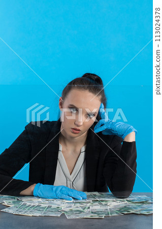 Scattered paper banknotes on the counter of a young cashier during a lot of money. Scattered paper banknotes on the counter of a young cashier during a lot of money. 113024378