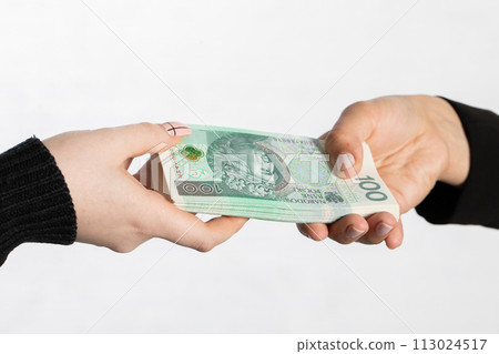 The businesswoman hands a bundle of banknotes as an additional bonus to the salary. 113024517