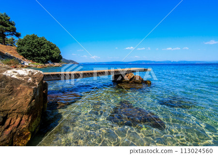 Beautiful scene from wooden pier and turquoise sea.Tarsanas Beach, Thassos, Greece 113024560