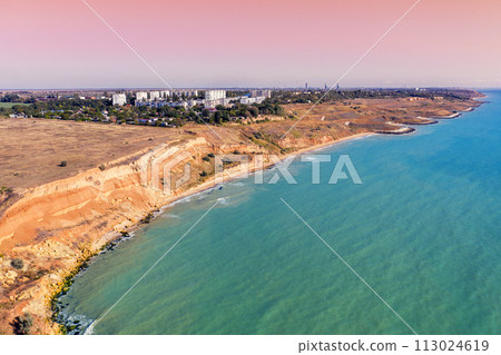 Seascape with sea and city on the clay steep coast. Aerial view of Chornomorske, Odesa, Ukraine Seascape with sea and city on the clay steep coast. Aerial view of Chornomorske, Odesa, Ukraine 113024619