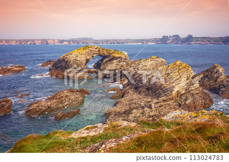 Seascape with the rocky shore in spring. View of Ria de Ribadeo del Eo bay. Rock with the natural arch. Ribadeo, Spain 113024783