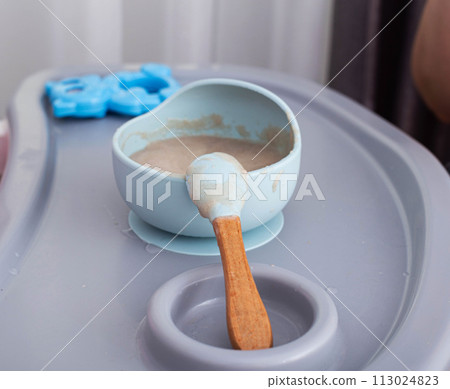 Buckwheat porridge for children in a plate. Feeding children healthy porridge, close-up 113024823