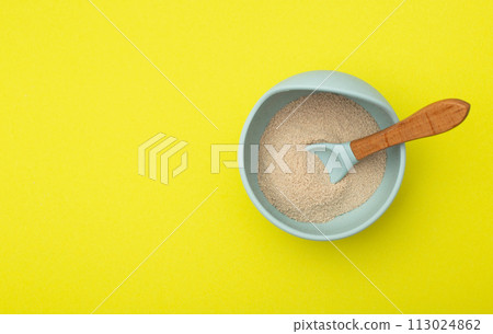 Dairy-free vitamin buckwheat porridge in a plate on a yellow background. Baby food with minerals. Copy space for text, vegetable protein Dairy-free vitamin buckwheat porridge in a plate on a yellow background. Baby food with minerals. Copy space for text, vegetable protein 113024862