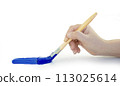Hand holding paint brush blue on a white background 113025614