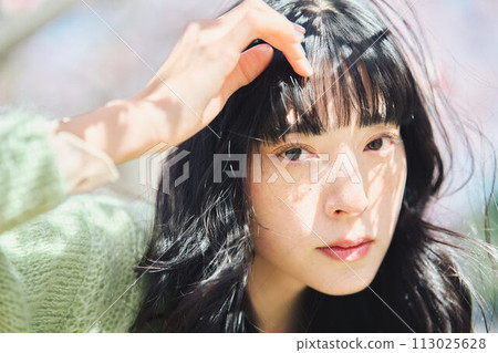 Portrait of a beautiful woman with cherry blossoms Portrait of a beautiful woman with cherry blossoms 113025628