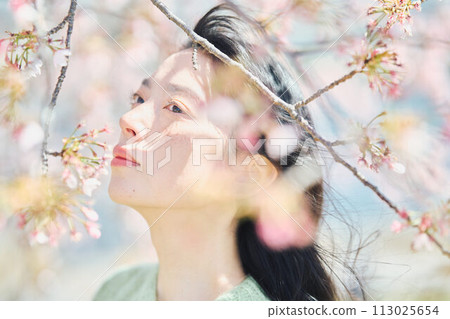 Portrait of a beautiful woman with cherry blossoms Portrait of a beautiful woman with cherry blossoms 113025654
