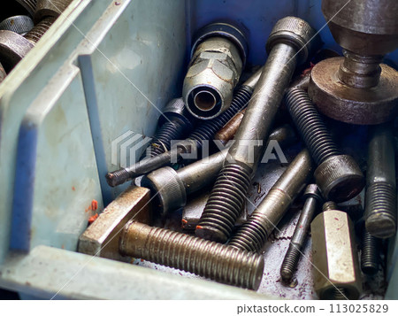 Detail of different metallic bolts and nuts in the toolbox Detail of different metallic bolts and nuts in the toolbox 113025829