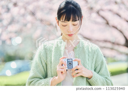 Women taking photos of cherry blossoms Women taking photos of cherry blossoms 113025940