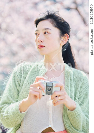 Women taking photos of cherry blossoms Women taking photos of cherry blossoms 113025949