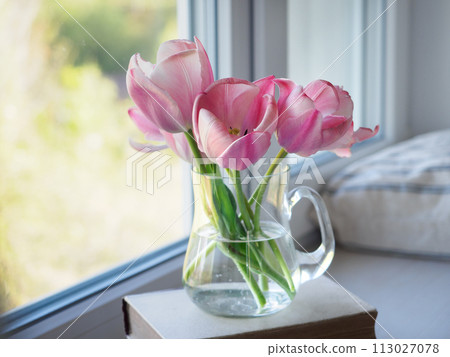 Bouquet of bright flowers standing in a vase on the table Bouquet of bright flowers standing in a vase on the table 113027078