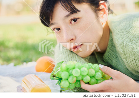 A woman enjoying a picnic A woman enjoying a picnic 113027181