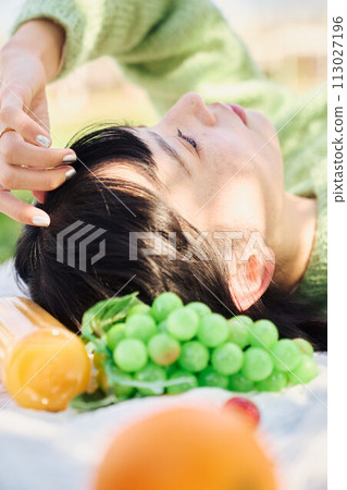 A woman enjoying a picnic 113027196