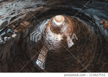 A deep view into the interior of the Krasno lookout tower, showcasing the circular stone architecture and ascending perspective. 113027552