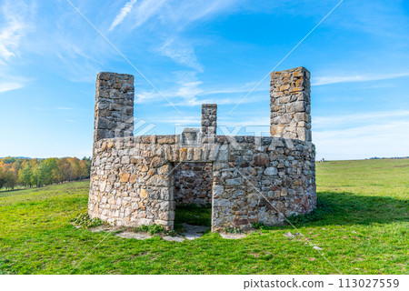 A stone structure standing in Horni Slavkov, which historically served as an execution ground, set against a clear blue sky and open field. Czechia A stone structure standing in Horni Slavkov, which historically served as an execution ground, set against a clear blue sky and open field. Czechia 113027559