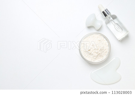 Collagen powder in a bowl on a light background 113028003