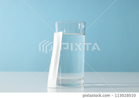 Collagen in a white stick with a glass of water 113028010