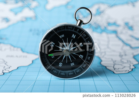 Compass on the background of the world map. Compass on the background of the world map. 113028026