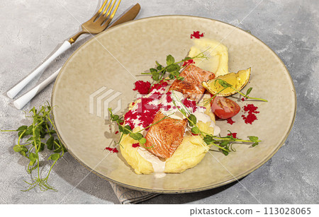 Salmon with mashed potatoes, topped with white sauce and garnished with caviar and pea sprouts. Salmon with mashed potatoes, topped with white sauce and garnished with caviar and pea sprouts. 113028065
