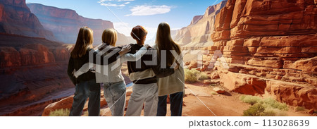 Four people, friends stand and admire view, landscapes. Deep, sandy canyon lit by pleasant daylight. 113028639