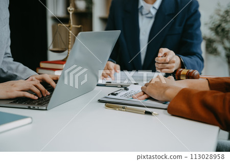 Teamwork of business lawyer meeting working hard about legal legislation in courtroom to help their customer. 113028958