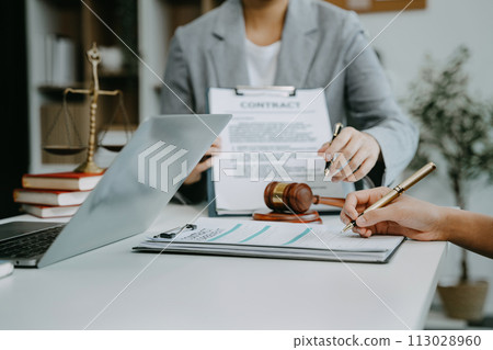 Legal counsel presents to the client a signed contract with legal law. justice and lawyer concept in office. Legal counsel presents to the client a signed contract with legal law. justice and lawyer concept in office. 113028960