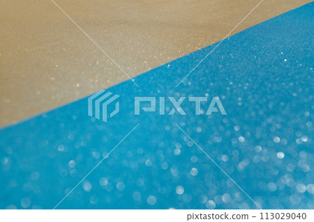 Abstract beach with glitter paper sand and water. Summer aesthetic mockup template background on a tropical beach holiday 113029040