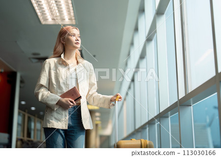 Airport travel and woman with passport, flight ticket or information of immigration, journey and luggage. identity document and international registration Airport travel and woman with passport, flight ticket or information of immigration, journey and luggage. identity document and international registration 113030166