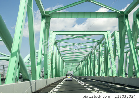 Cars running on an emerald green steel road Cars running on an emerald green steel road 113032024