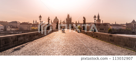 Morning on Charles Bridge, Czech: Karluv most. Hazy sunrise daybreak. Praha, Czech Republic. 113032907