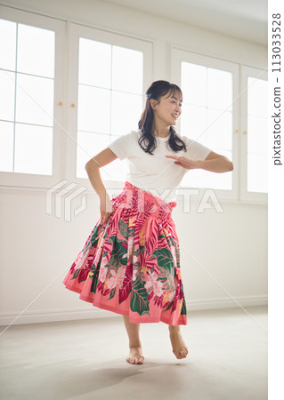 Middle-aged woman dancing hula dance Middle-aged woman dancing hula dance 113033528